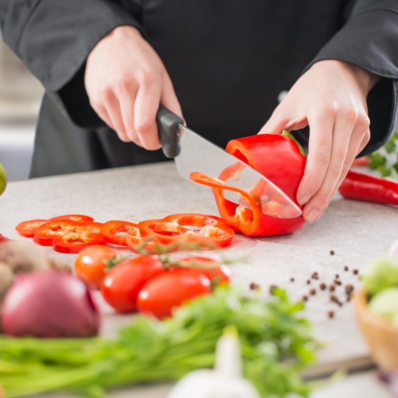chef cooking food kitchen restaurant cutting prepare cook hands healthy hotel man male knife preparation fresh preparing young natural culinary domestic desktop dietary red concept - stock image